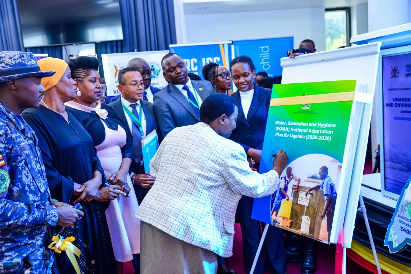 Prime Minister Robinah Nabbanja signs a ceremonial dummy copy to officially launch Uganda&rsquo;s Water, Sanitation and Hygiene National Adaptation Plan (WASH-NAP) during the 9th Uganda Water and Environment Week, as other dignitaries look on, marking a global first in climate-resilient WASH planning.