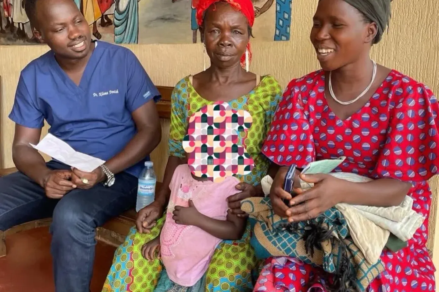 Dr Denish Kilama counsels the caregiver of a young child diagnosed with congenital glaucoma at Yotkom Hospital in Kitgum District. The child&rsquo;s name has been withheld to protect their identity.