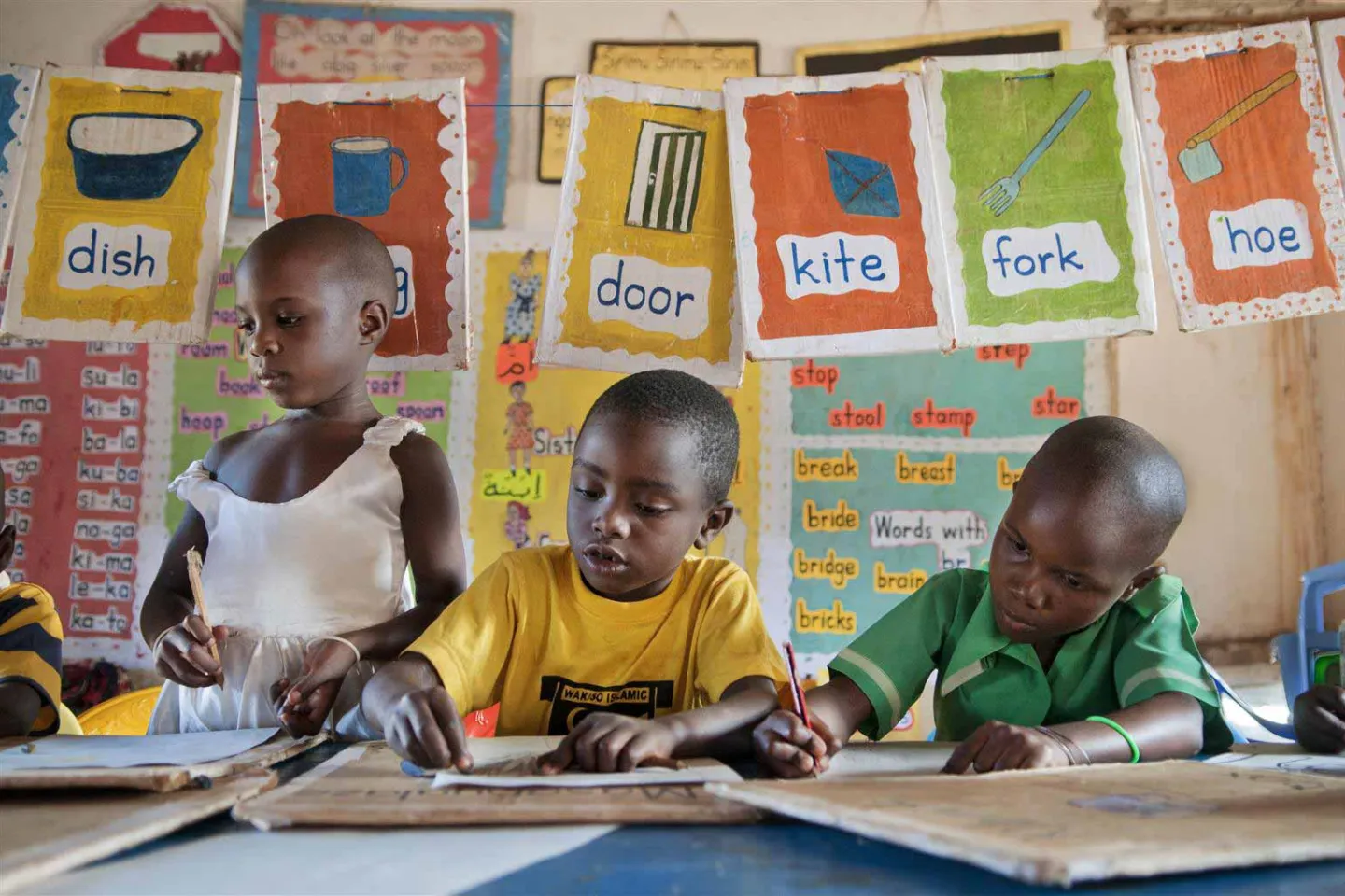 Three children doing school work