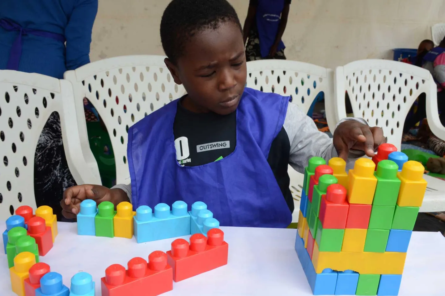 A boy plays with building blocks