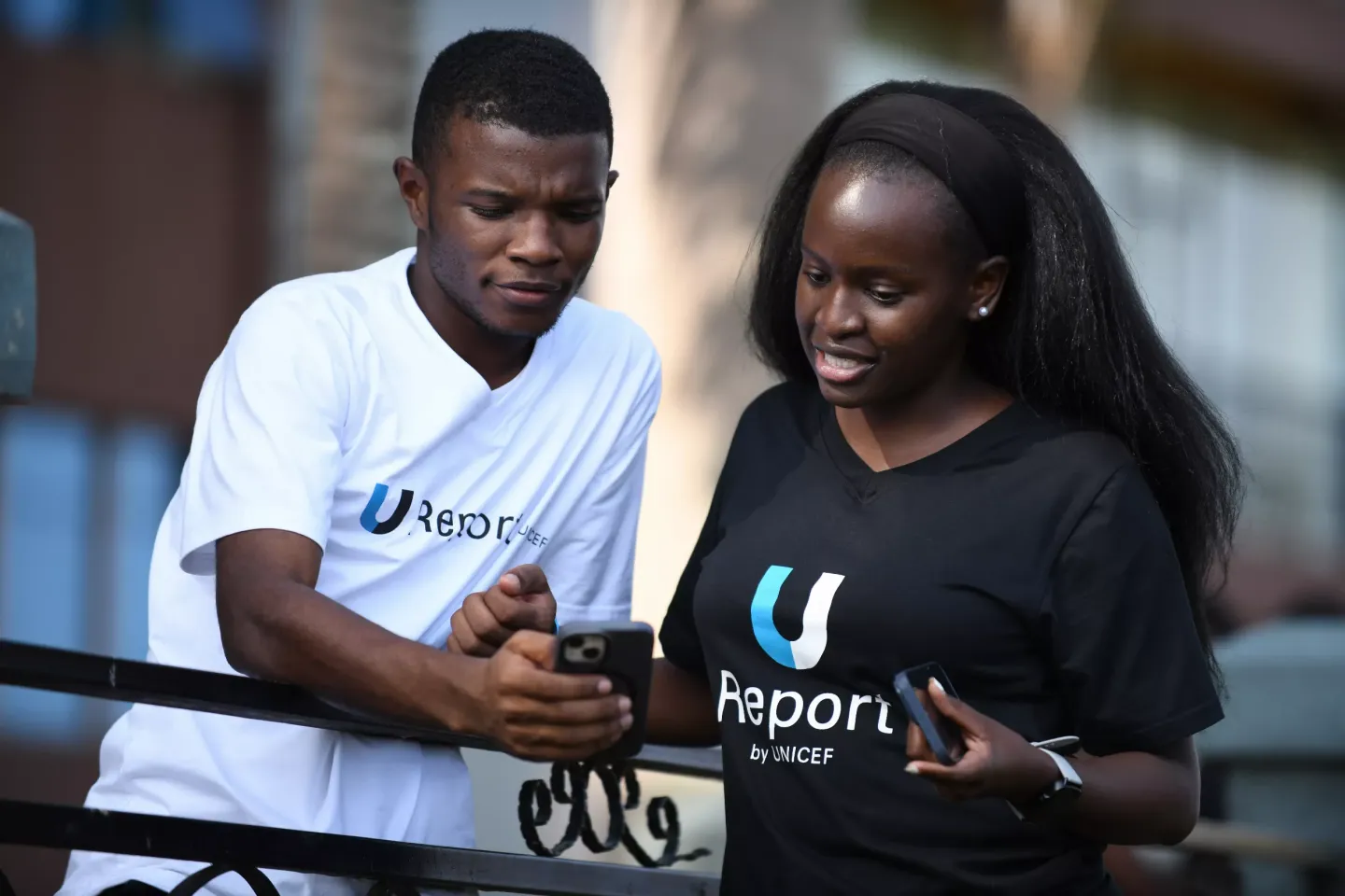 Tuyisenge Kenneth and Amongin Martha Christine share a U-Report message. The trio are beneficiaries of the UNICEF training of trainers for U-Report Communities for vaccination awareness and coverage improvement reads a U-Report message. Picture taken at Protea Hotel Entebbe in Kampala on September 27, 2024.