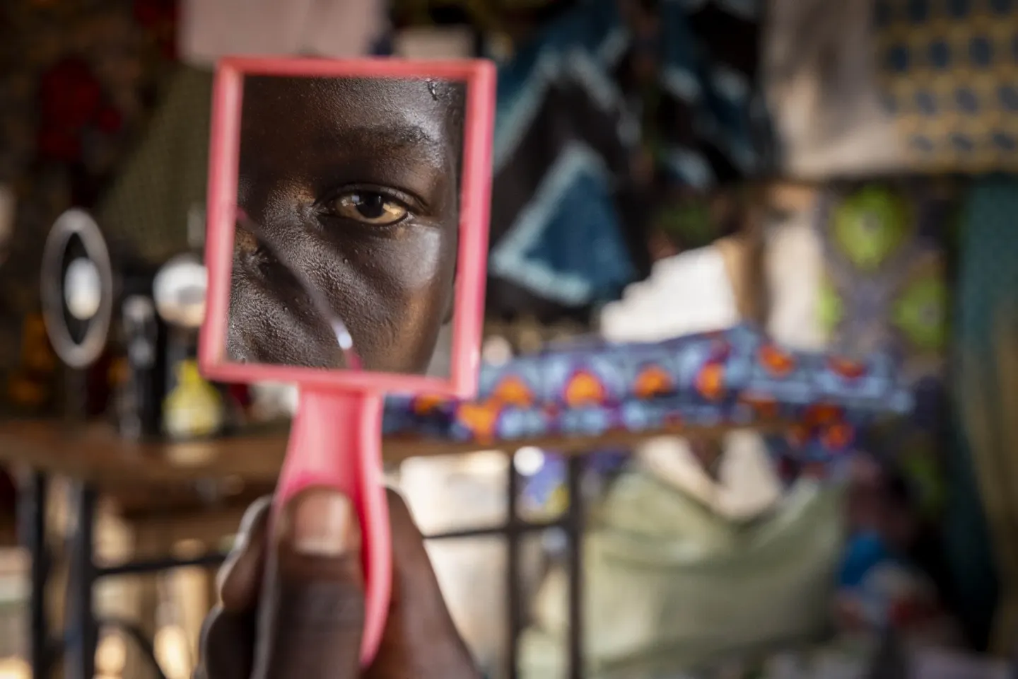 Ida Merusa (name changed), 16, inside her tailoring stall at Point J Market in Imvepi Refugee Settlement, Terego District.