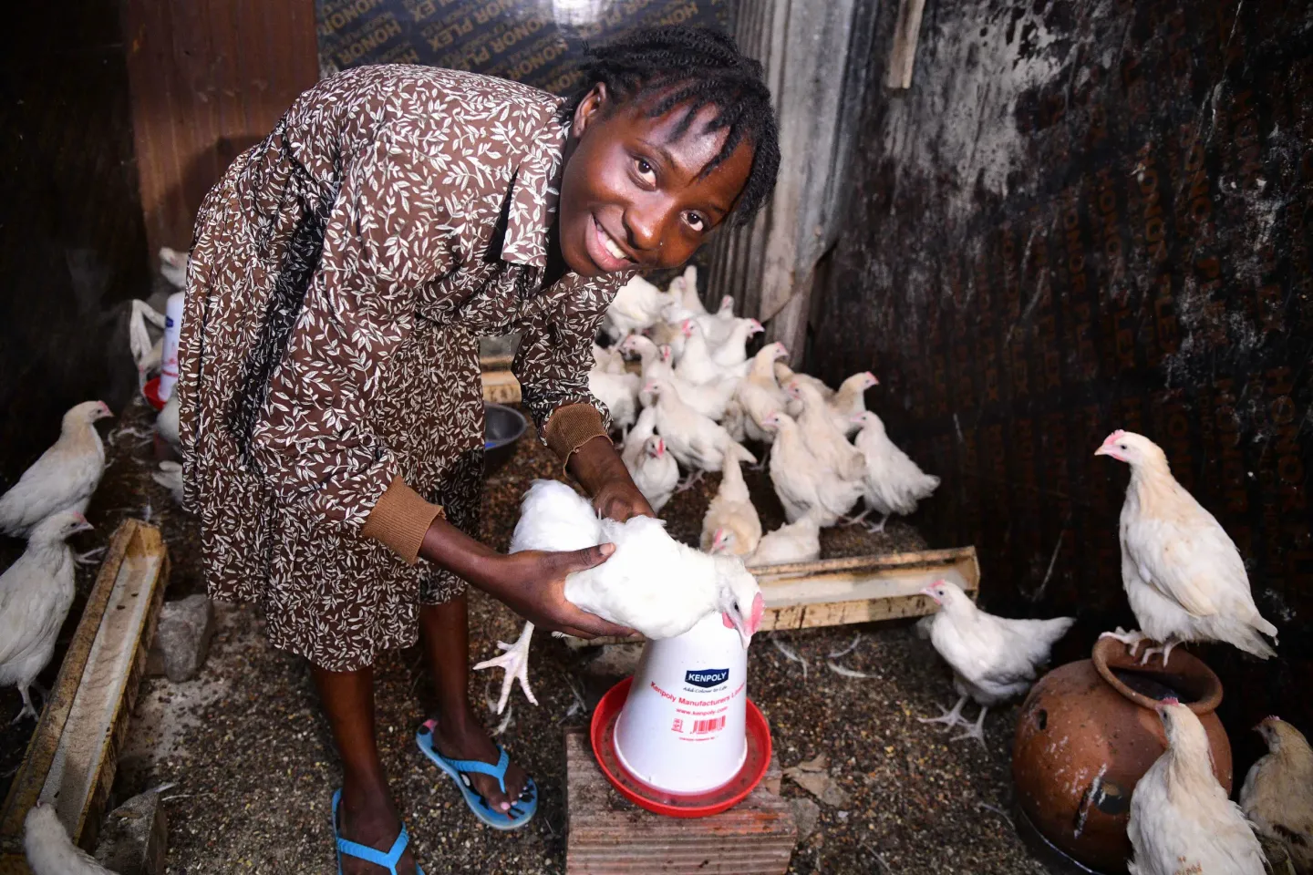 Ndibalekera Maria Judith, one of the beneficiaries of the Girls Empowering Girls (GEG) program attends to her poultry project in the backyard of her home in Kisenyi Zone in Kampala district. 