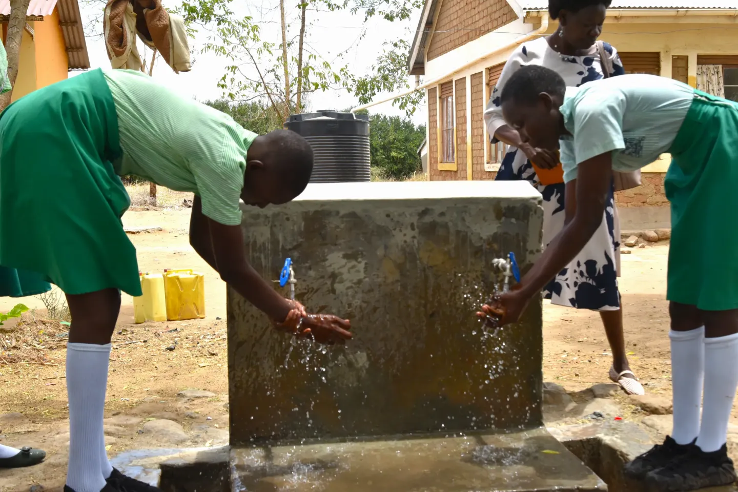 Girls at Kalotom Primary School in Napak District wash their hands at a tap stand installed under the UNICEF-KOICA climate-resilient WASH project. The school's restored solar-powered water system now provides safe and clean water to 1,259 pupils.