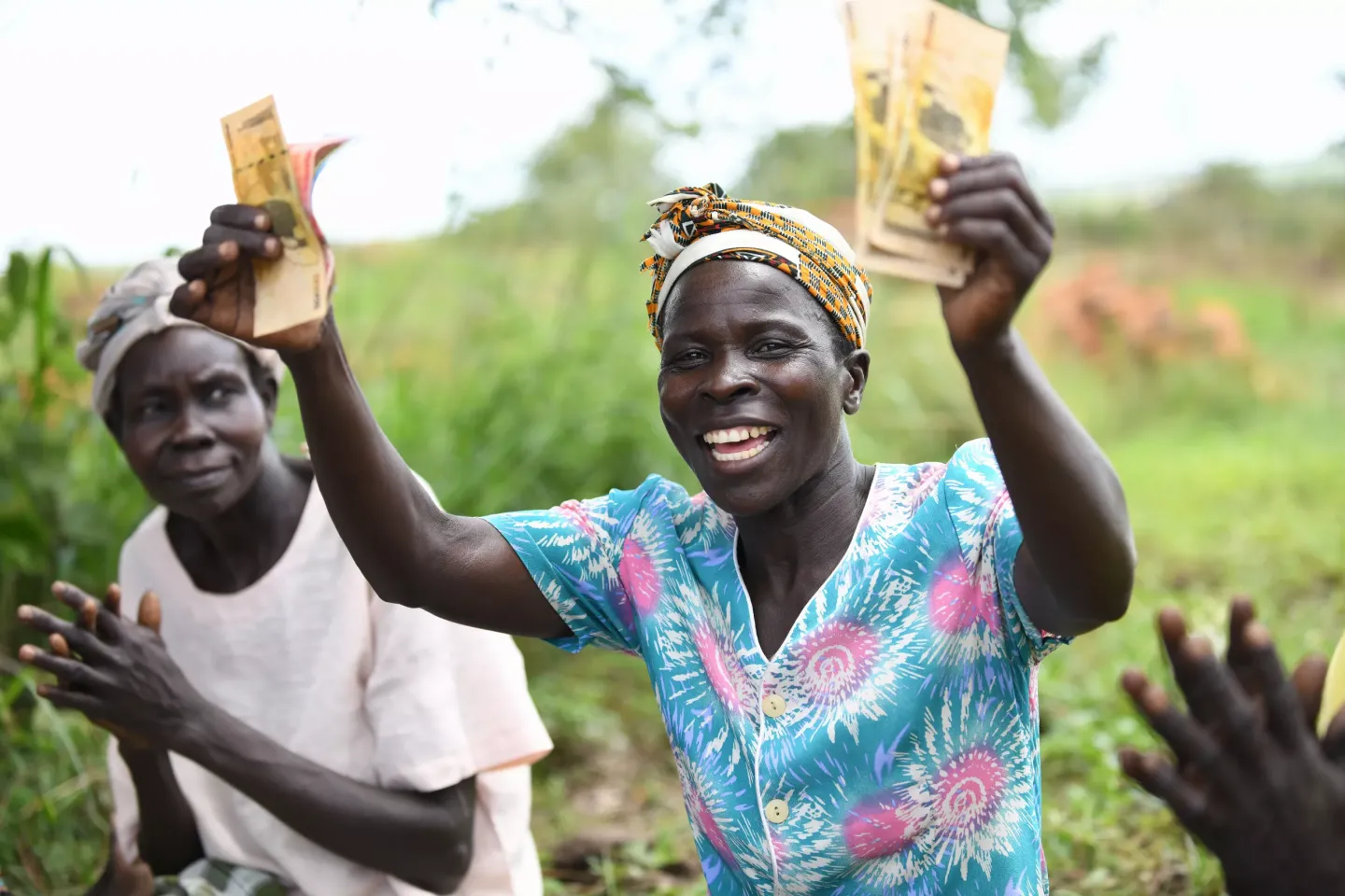 Oyella Lucy is a member of the Obed Ki Gen Village Savings Loans Aassociation in Apyetta parish in Lamwo district displays her EmpowerU CASH+ before depositing it on her account.