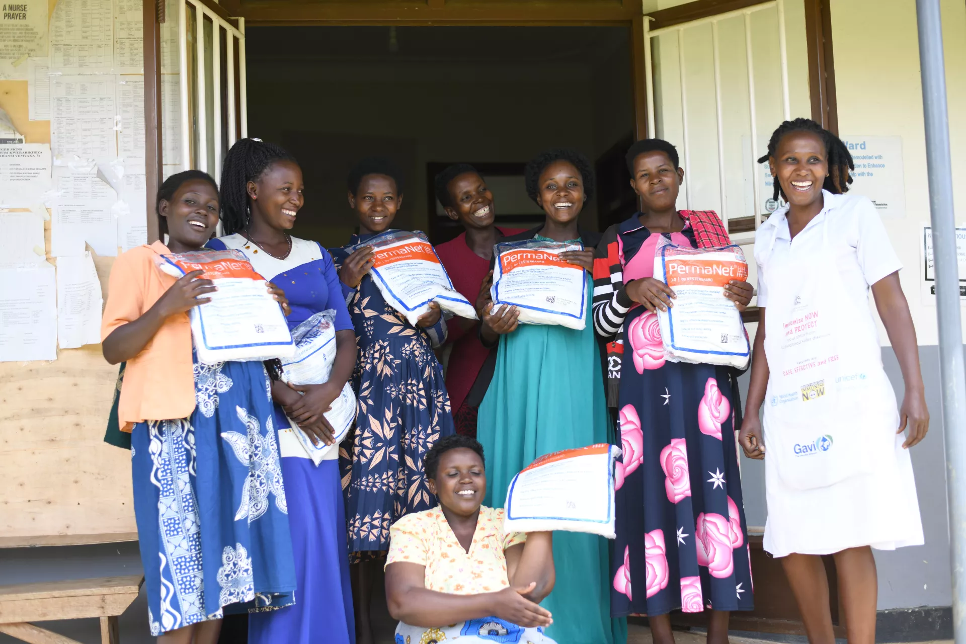 Pregnant mothers including Tumuhaise Catherine, Asiimwe Macureti, Kobusingye Joventa, Kyogabwirwe Rose, Tusingwire Meellon, Akankwatsa Mallion and Naturinda Barbra posse for a group picture with their midwife Ndinawe Brenda after receiving mosquito nets at the antenatal ward at Kitondo Health Center III in Ntungamo district. UNUCEF in partnership with ministry of health are giving free Mosquito nets to children and pregnant mothers to prevent malaria. Picture taken at Kitondo Health Center III in Ntungamo d