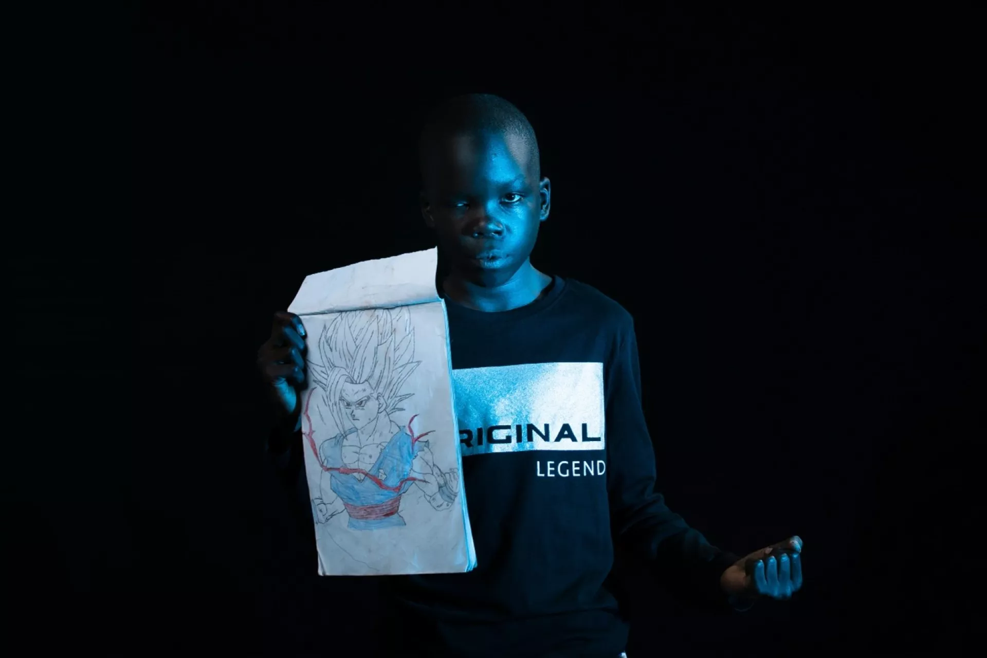 Amani Israel with one of his drawings. &ldquo;Children like disturbing me at school, so when I am sad, I draw pictures of cartoons I saw on my mum&rsquo;s phone and show them to my friends,&rdquo; Eleven-year-old Aman says.