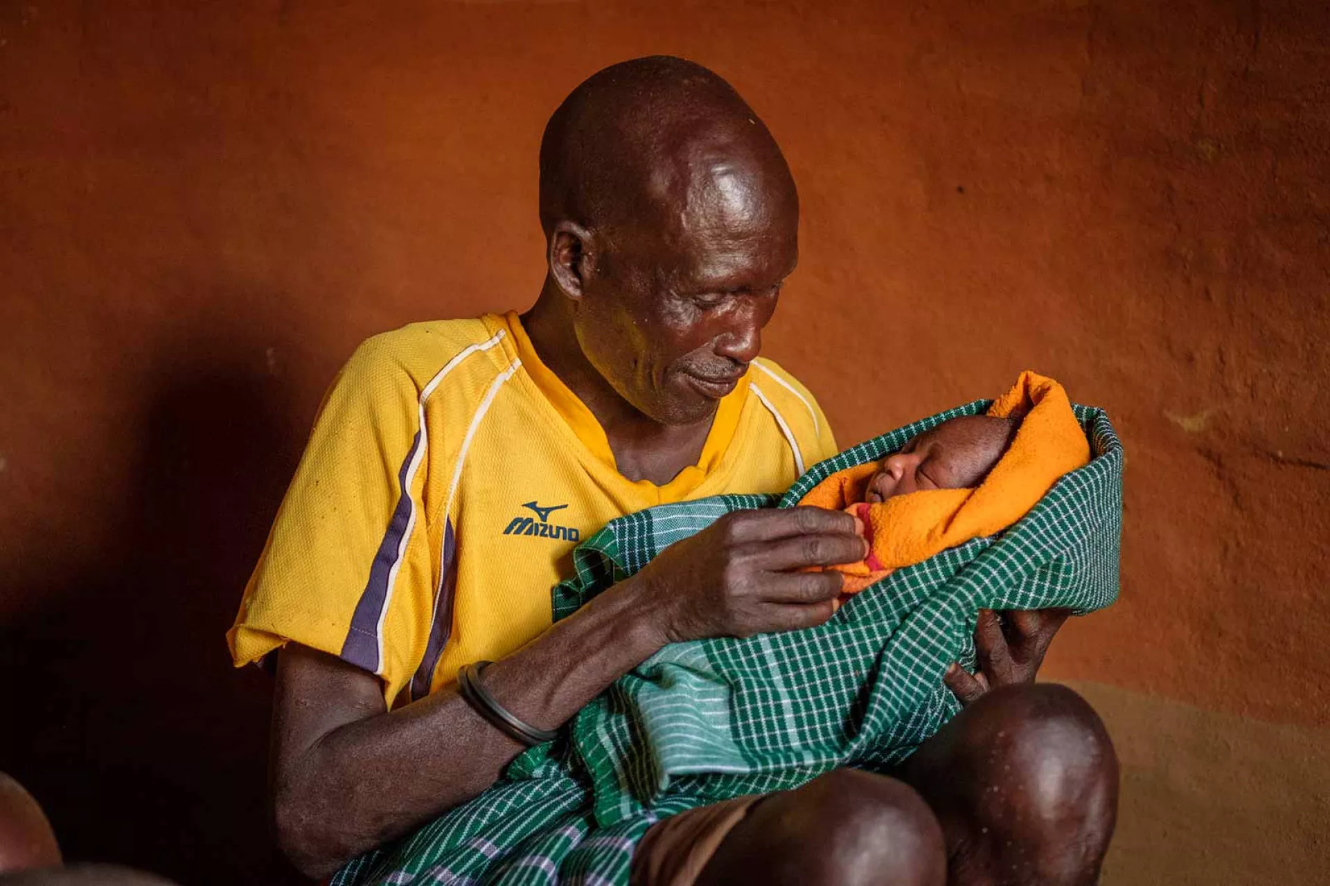 A man holds a baby