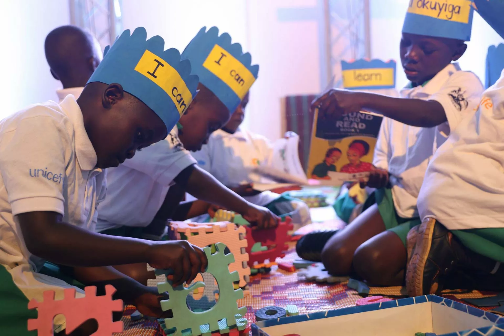 Young children play with toys on the floor