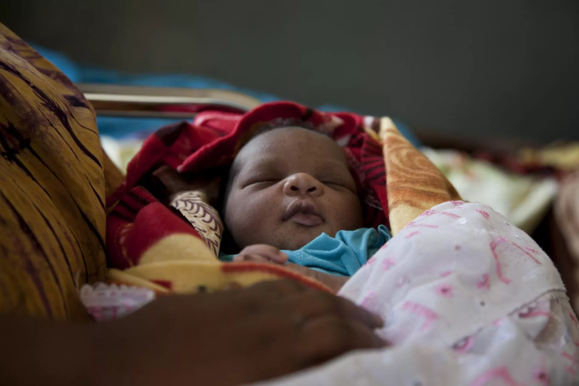 A baby bundled and held