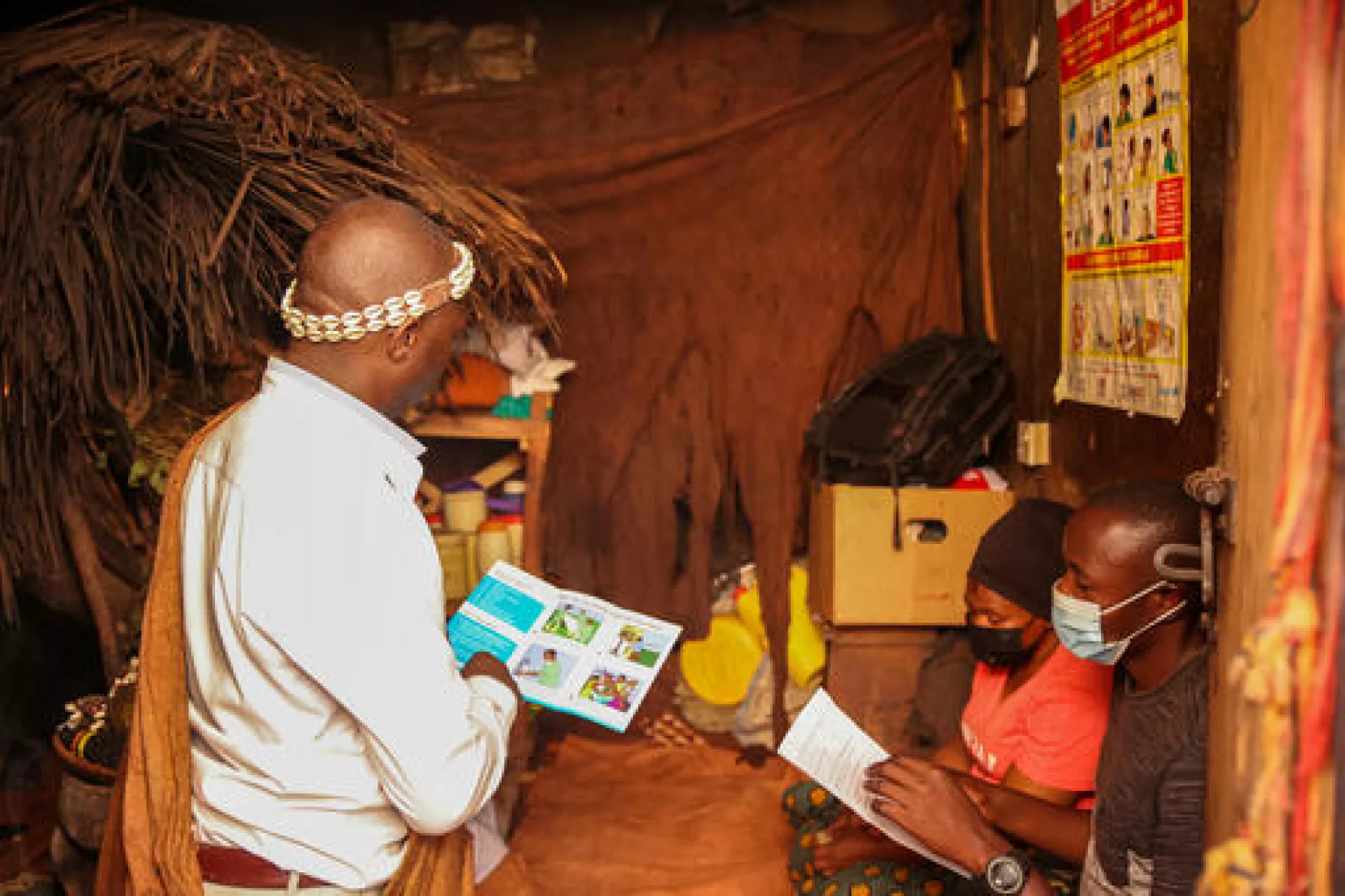 Mr Katende Jackson, a traditional healer in Nsuwa Zone, Makindye Division, Kampala; talks to his clients about Ebola using Risk Communication and Community Engagement materials generated with support from UNICEF.