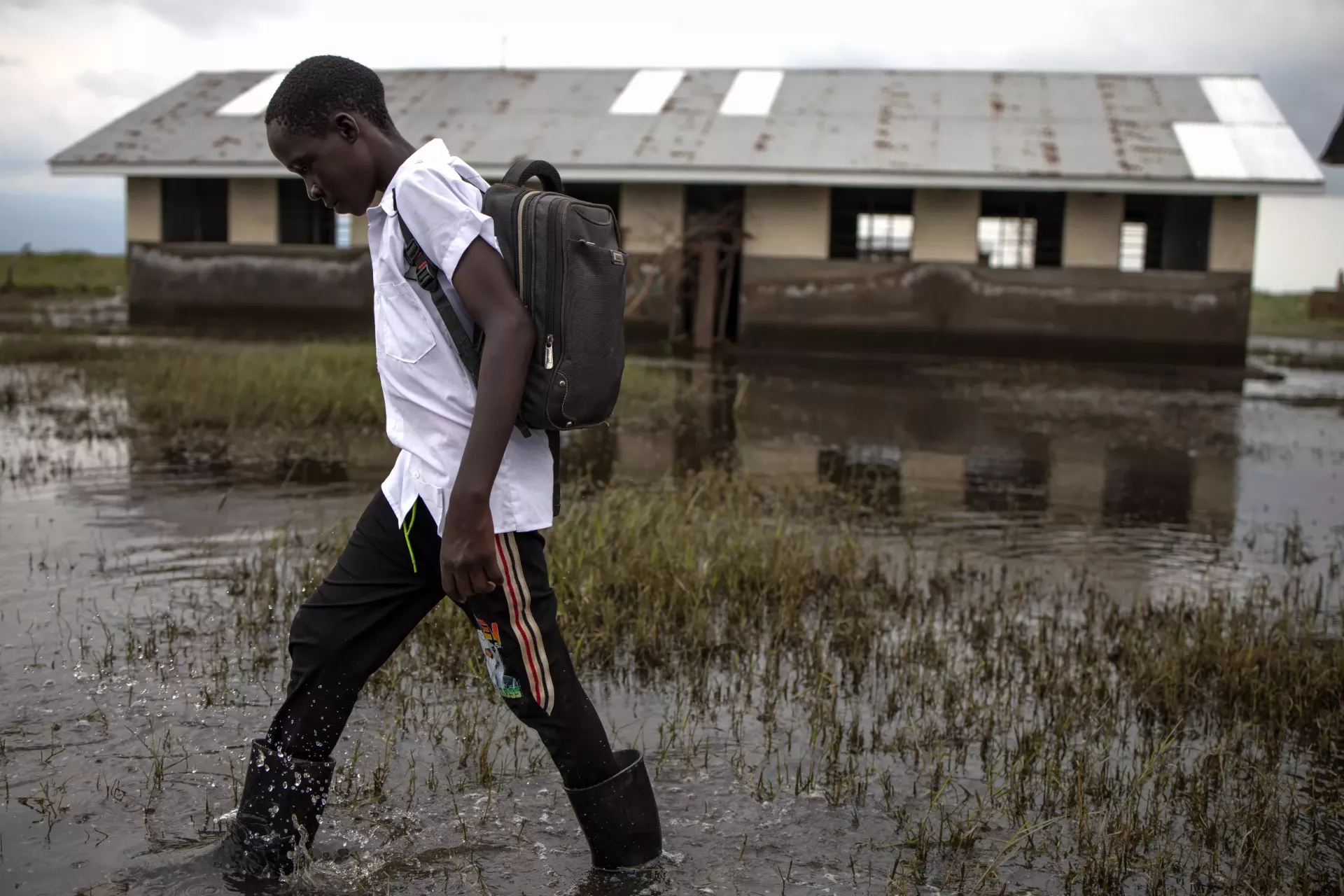 Francis Tusiime, 15, a Primary Seven pupil at Masaka Primary School in Butungama Sub-county, Ntoroko District, makes his way out of the school premises on September 4, 2024. 