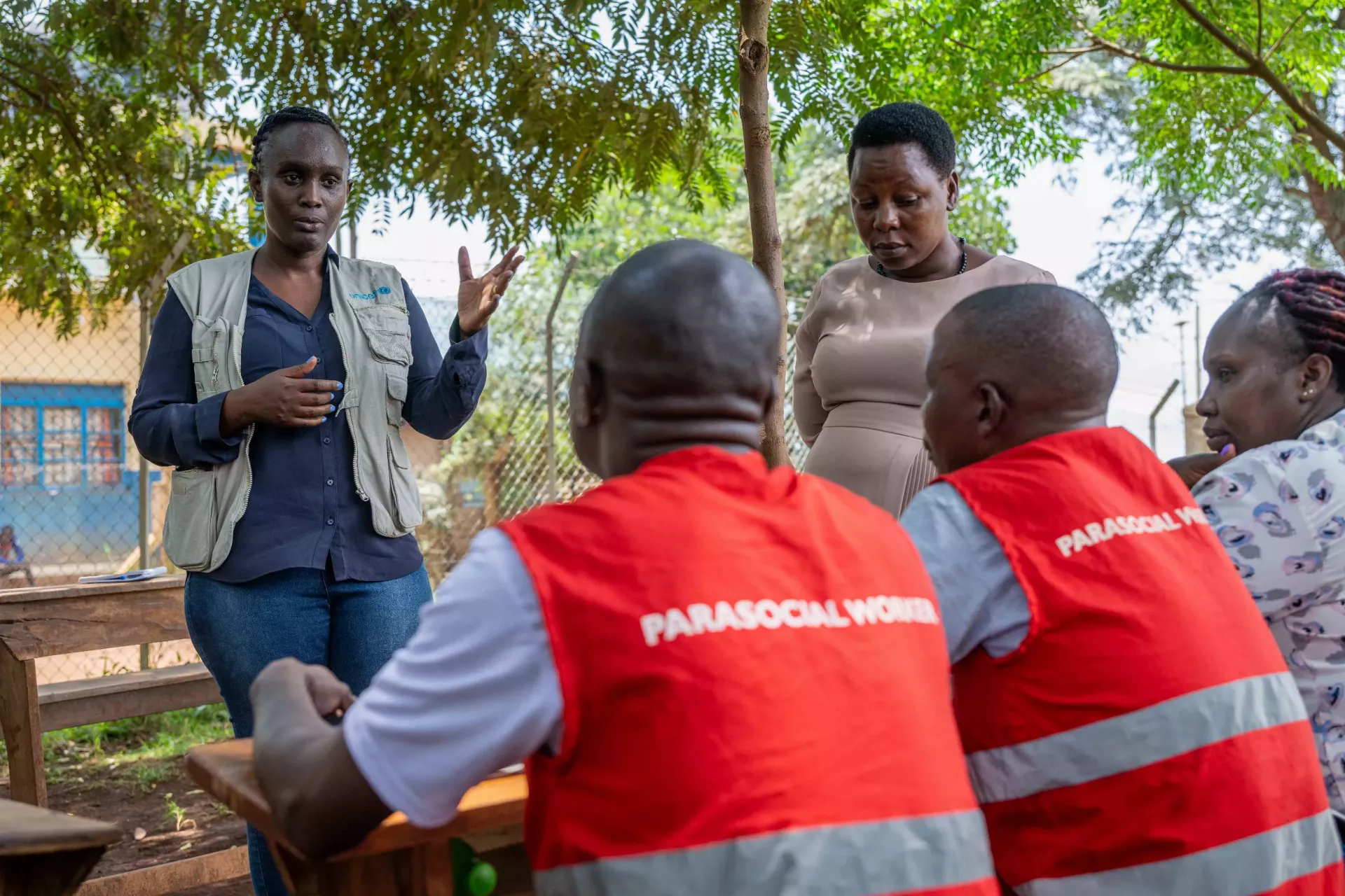 Allen Uhirwe UNICEF Child protection Officer interacts with para social workers at Kinaketkaka Primary school during the para social worker meetings in communities.