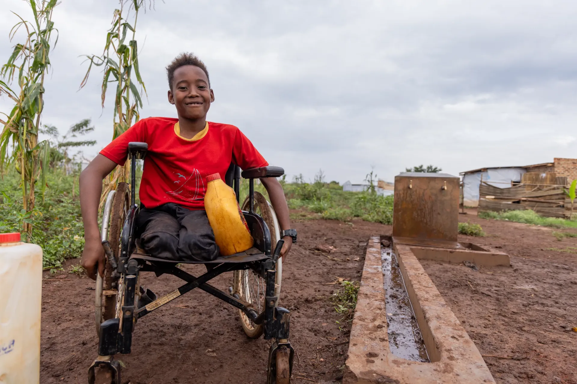 'Now my boy can also take water in the jerrycan on his wheelchair and bring it home .' - Maxada Ibrahim Ahmed, &nbsp;Mother of 3, living in Cluster L, Kiryandongo Refugee settlement.