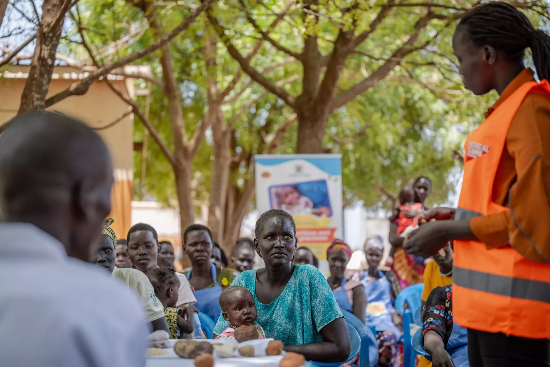 Atoch Riak, together with Aguer Deng (1 years old) a child she takes care of both attend a Community training on nutrition held at Nyumanzi refugee settlement in Adjumani.