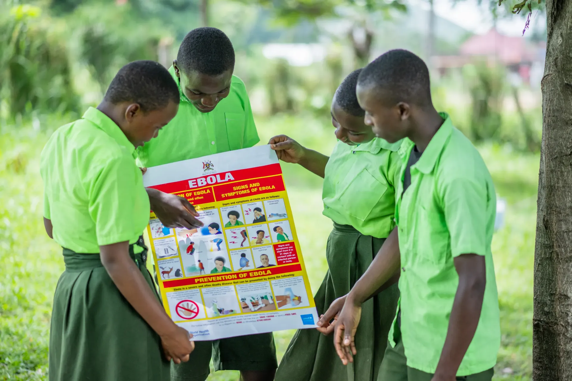 Pupils of Karugutu Primary school reading a poster containing information on how to avoid Ebola at Karugutu primary school in Ntoroko District on 29.04.2025