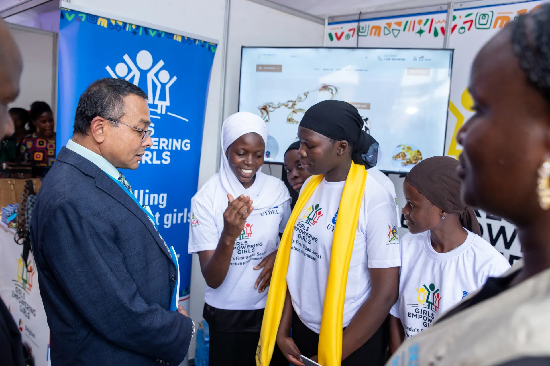 Dr Robin Nandy, the UNICEF Representative to Uganda, tours exhibition stalls by the beneficiaries at the close-out event. Evidence consistently shows that investing in adolescent girls yields high social and economic returns&mdash;including improved lifetime earnings, reduced early pregnancies, and stronger participation in society (World Bank, Adolescent Girls Initiative Report, 2020).