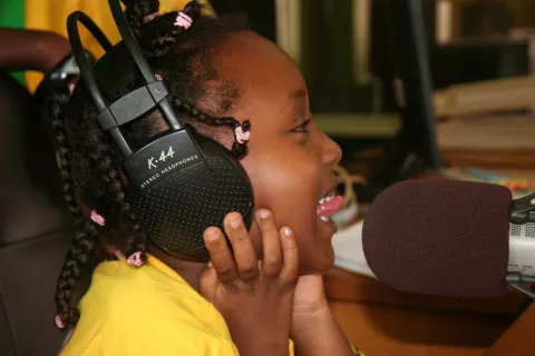 A girl speaks into a microphone