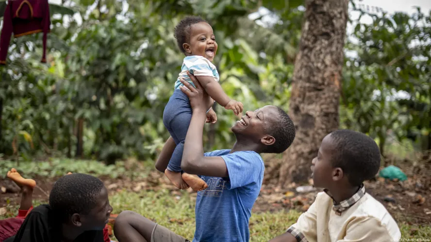 Twelve-year-old Bashir plays with his baby brother and as two other siblings look on at their home in Wakiso.