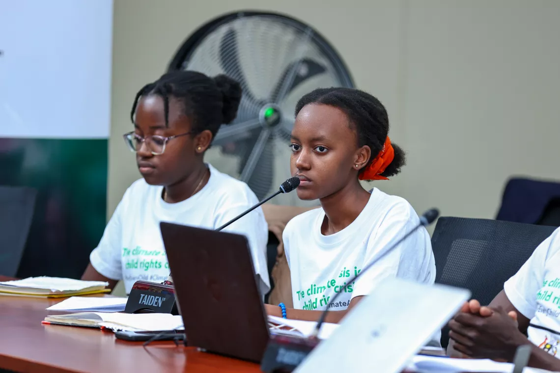 Youth representatives, Valerie(L) and Vannessa (R) listen in to delibarations at a session organised between officials from the Ministry of Water and Environment and children and youth representatives, by Youth-Go-Green initiative and UNICEF.