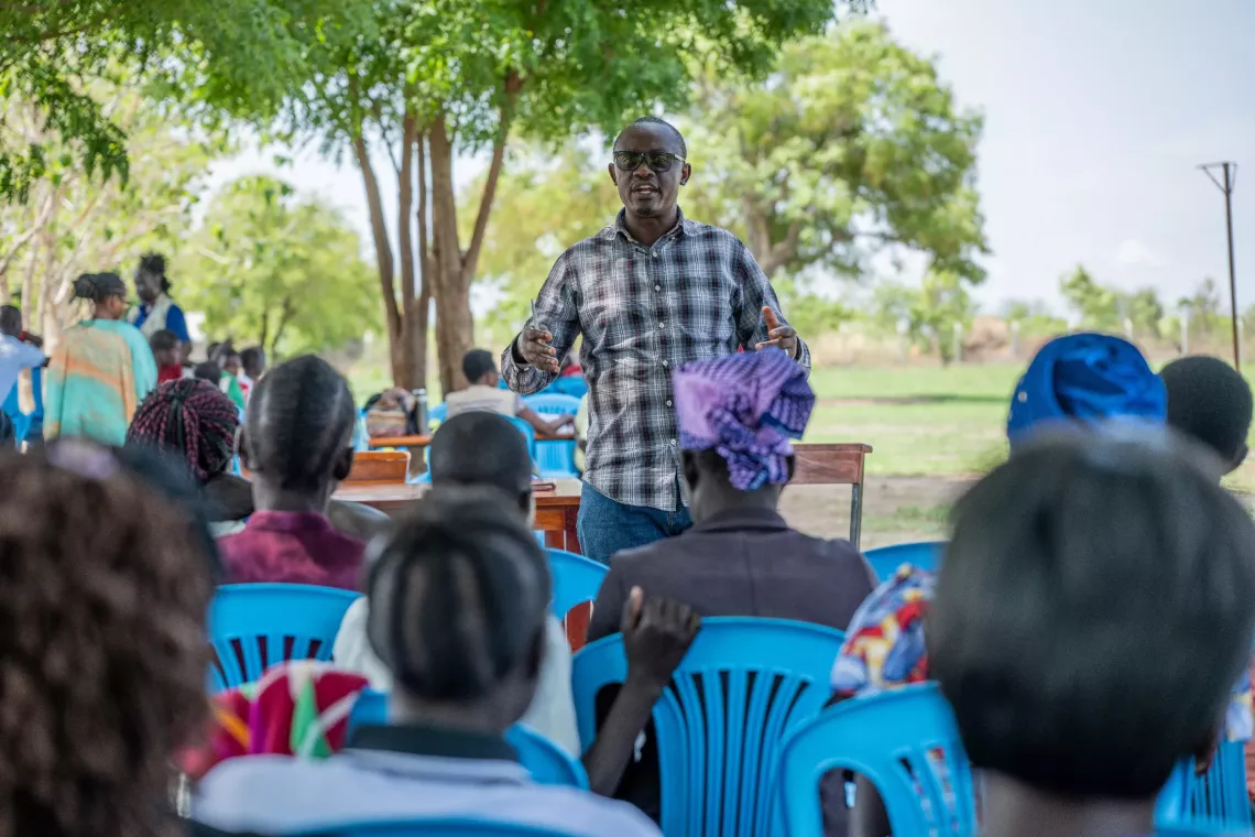 Francis a social protection officer from Ministry Of gender labor and social development addressing parents at Palabek Secondary school, talking about the Cashplus program school fees for girls in secondary schools.