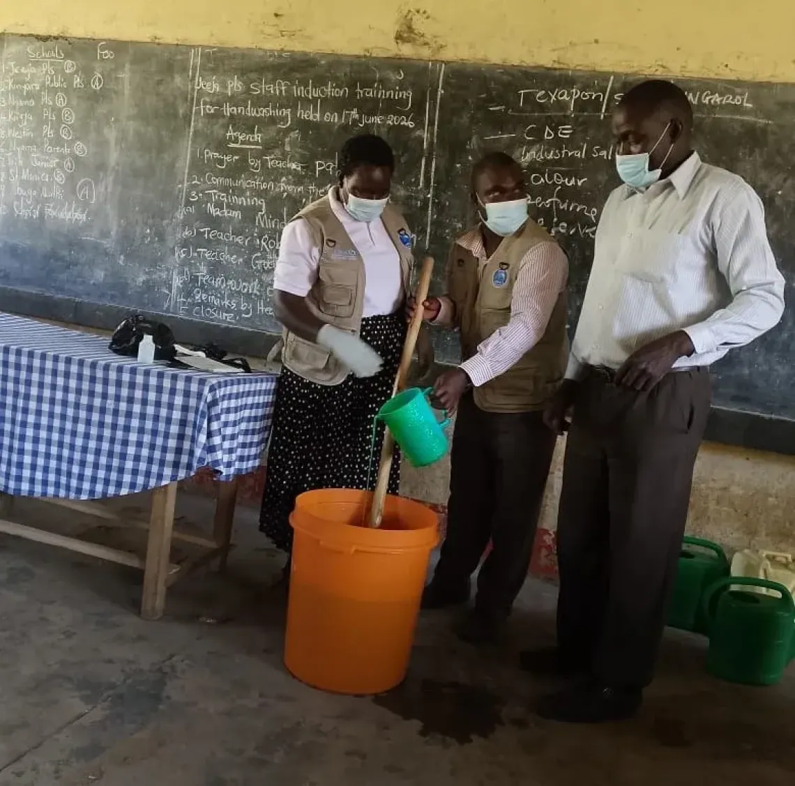 Teachers make a batch of liquid soap during a staff induction session on handwashing, June 2026. Soap making was the most valued component of the Handwashing Ambassadors training, delivered by the Ministry of Water and Environment with UNICEF support through the Japan Committee for UNICEF and Saraya Co., Ltd.