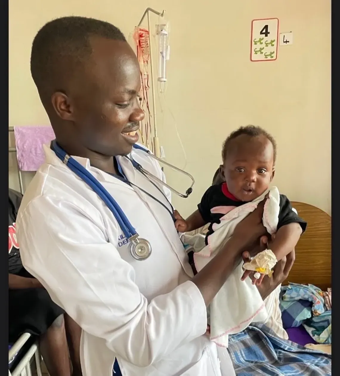 Dr Denish Kilama reviews a child admitted with severe malaria at Yotkom Hospital in Kitgum District. The child responded to treatment and was cleared for discharge the same day.