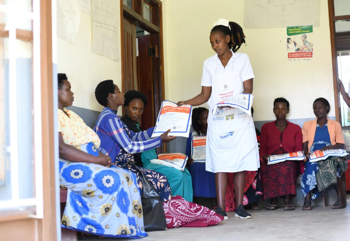 Ndinawe Brenda a midwife distributes mosquito nets to pregnant mothers including Kyogabwirwe Rose, Tumuhaise Catherine, Akankwatsa Mallion, Tusingwire Meellon and Asiimwe Macureti. This was at the antenatal ward at Kitondo Health Center III in Ntungamo district. Mosquito nets are some of the key interventions by UNICEF and ministry of health in the fight against malaria among children and pregnant mothers. Picture taken at Kitondo Health Center III in Ntungamo district on April 20, 2023