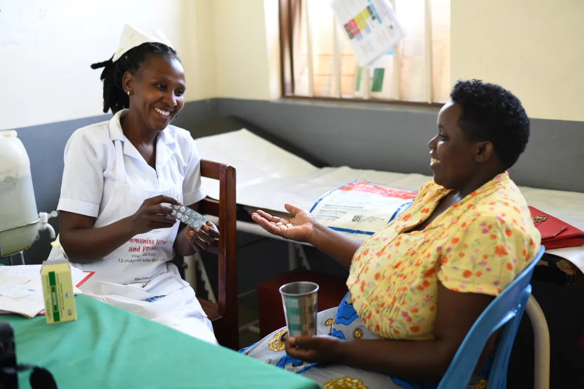 Ndinawe Brenda a midwife gives a Fansidar dose for malaria prevention to Tumuhaise Catherine, one of the pregnant mothers at the antenatal ward at Kitondo Health Center III in Ntungamo district. UNICEF in partnership with ministry of health have put up various interventions at health centers to prevent malaria among children and pregnant mothers.
