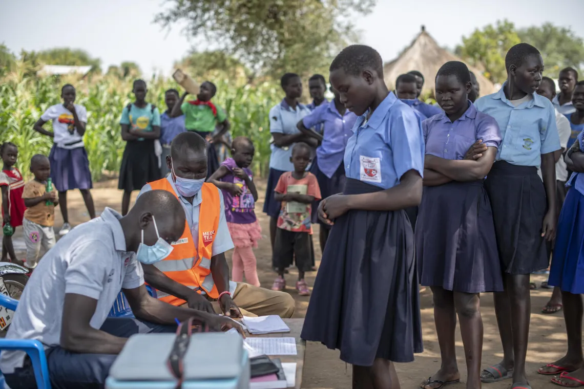 School children being registered for vaccination