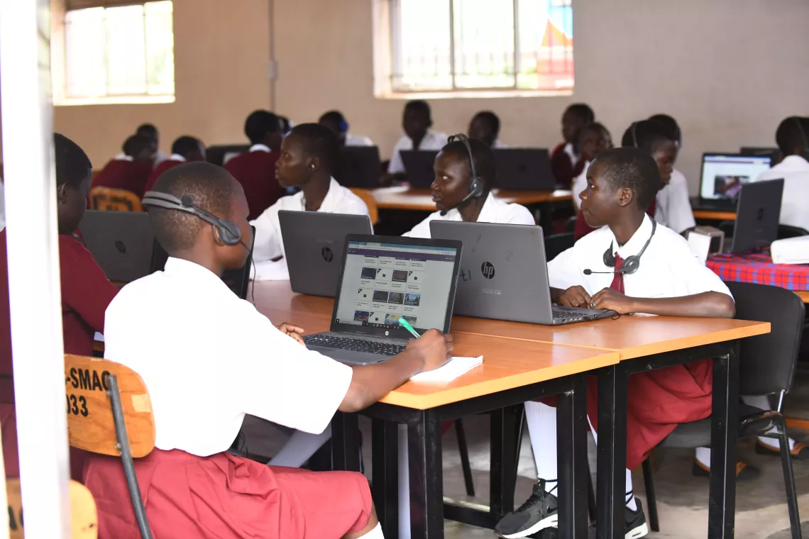 Students at St. Mary Asumpta Girls Secondary School Pekelle in Adjumani district attend a biology lesson online during the launch of the UNICEF and Airtel Africa partnership. 