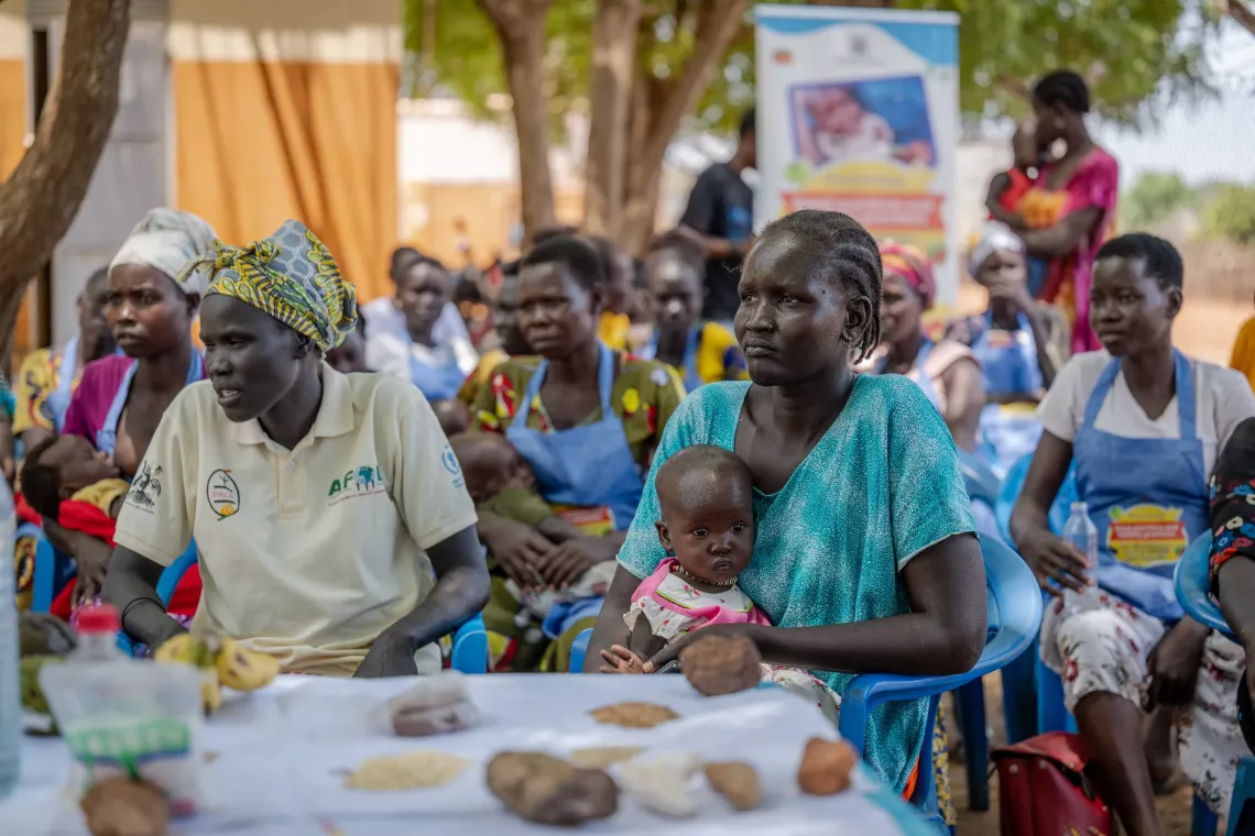 Atoch Riak, together with Aguer Deng (1 years old) a child she takes care of both attend a Community training on nutrition held at Nyumanzi refugee settlement in Adjumani.