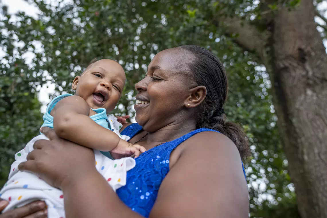 Christine Tuhaise, a mother from Kamwenge District, holds her four-month-old baby during the launch of the Egg Powder Initiative for Children (EPIC) in Kamwenge District. April 23rd 2025