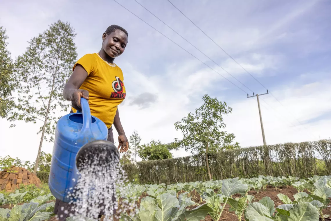 Jackline watering her vegetable garden at her home in Bukwanja Village, Buswale Sub-county, Namayingo District, 6 May 2025.