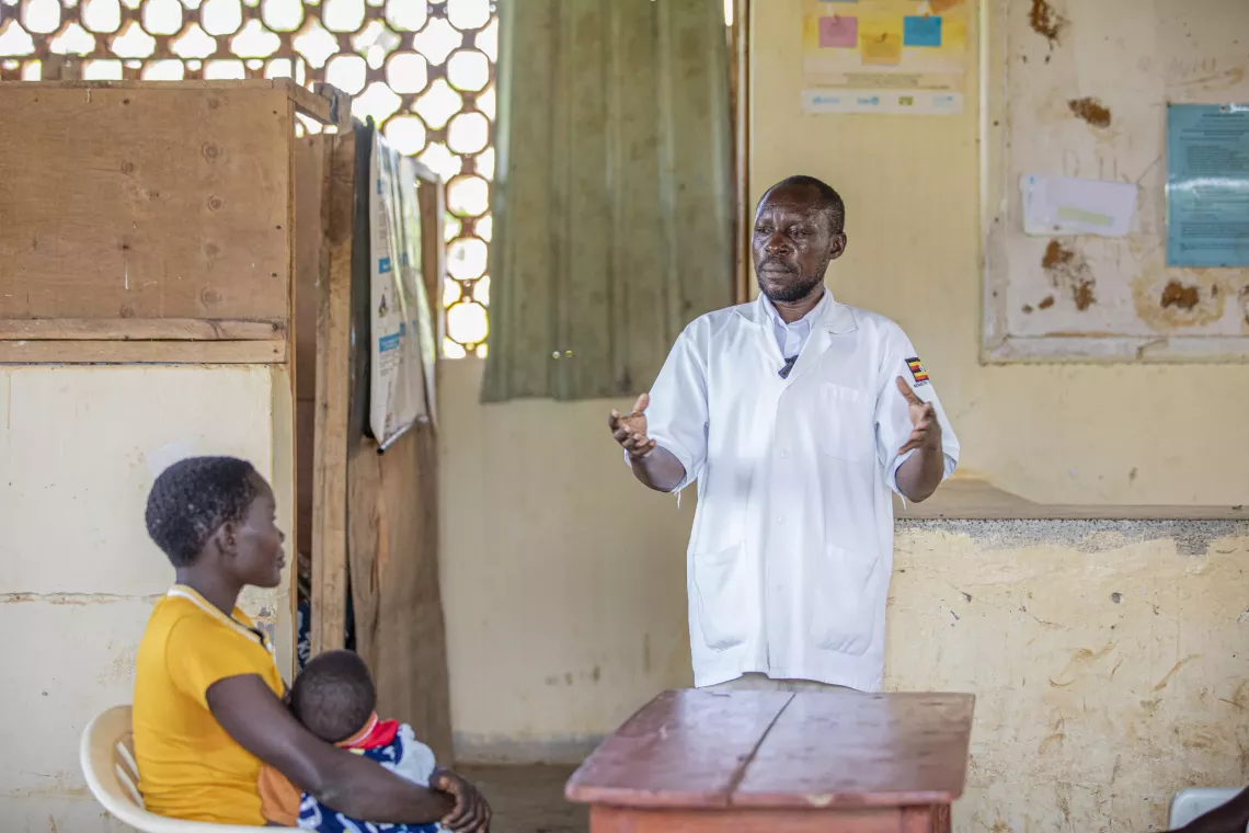 Jackline Nabwire, a 24-year-old mother listens to Sadat Mukasa, Assistant Nursing Officer, on good feeding habits, at Bumooli Health Centre III, Buswale Sub-county, Namayingo District, 6 May 2025.
