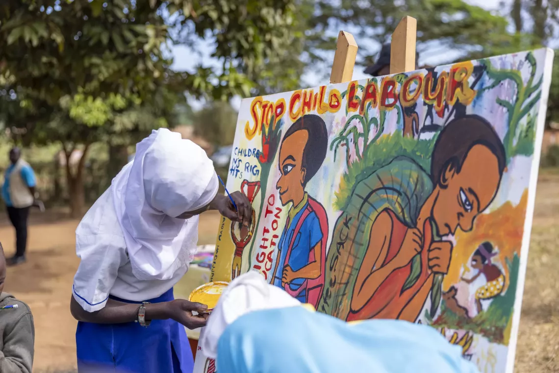 Children at Sala Good Primary School in Kalungu District display their artwork depicting the dangers of child labour, their rights and ideas for ending it.