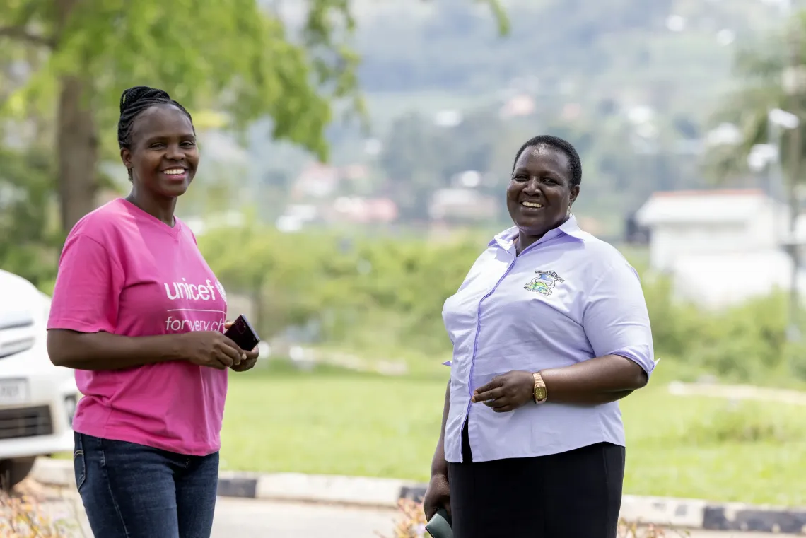 A portrait of Assistant District Health Officer Chemusto Beatrice and Dr. Sarah Acheng, UNICEF&rsquo;s Health Officer in Fort Portal, sharing a light moment at Ntungamo District Local Government headquarters. Their collaboration highlights ongoing efforts to strengthen immunisation services and reach children across the district.