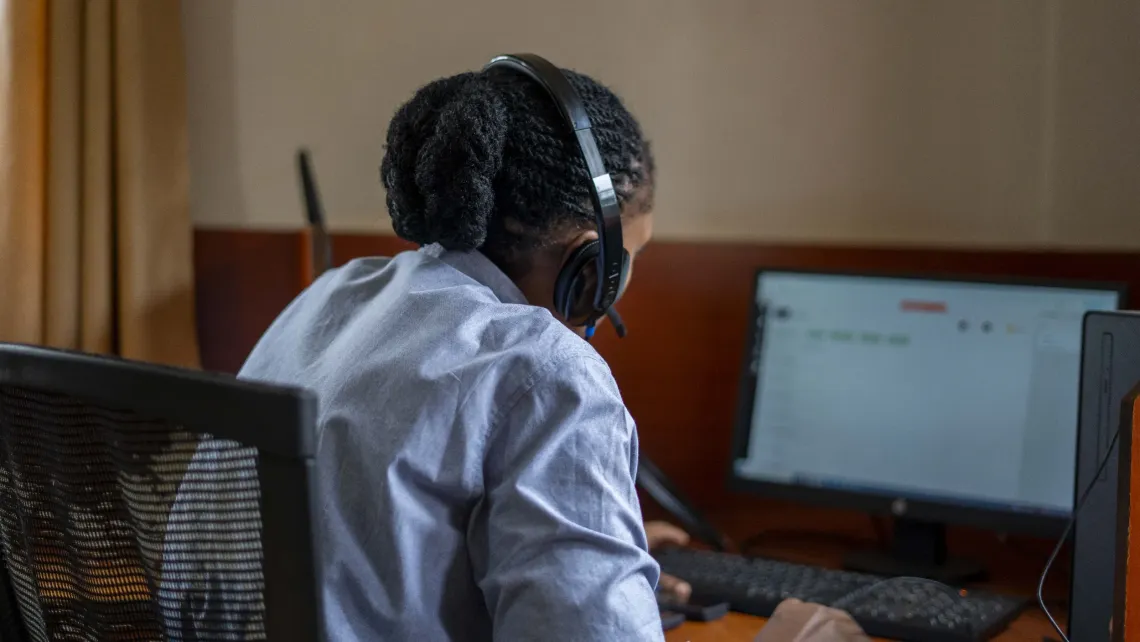 At the 24/7 SAUTI-116 call center in Kireka, Wakiso District, a case worker attends to a call. The center provides support to children and caregivers for reporting and responding to cases of violence against children and gender-based violence.