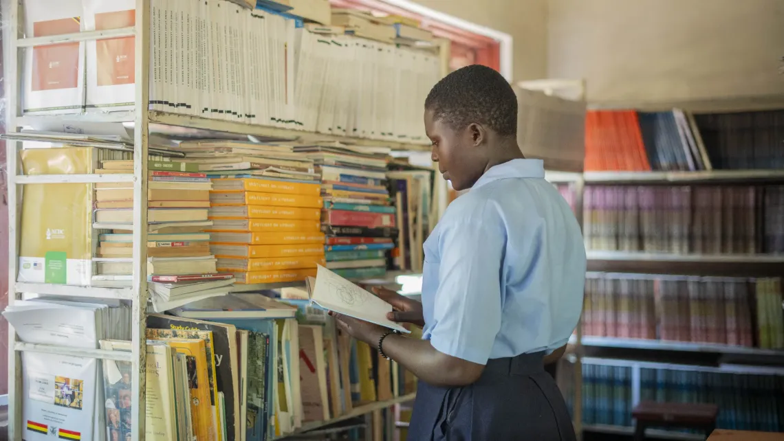 Sarah Fatuma, 19, studies in the library at Imvepi Senior Secondary School after re-enrolling to continue her education.