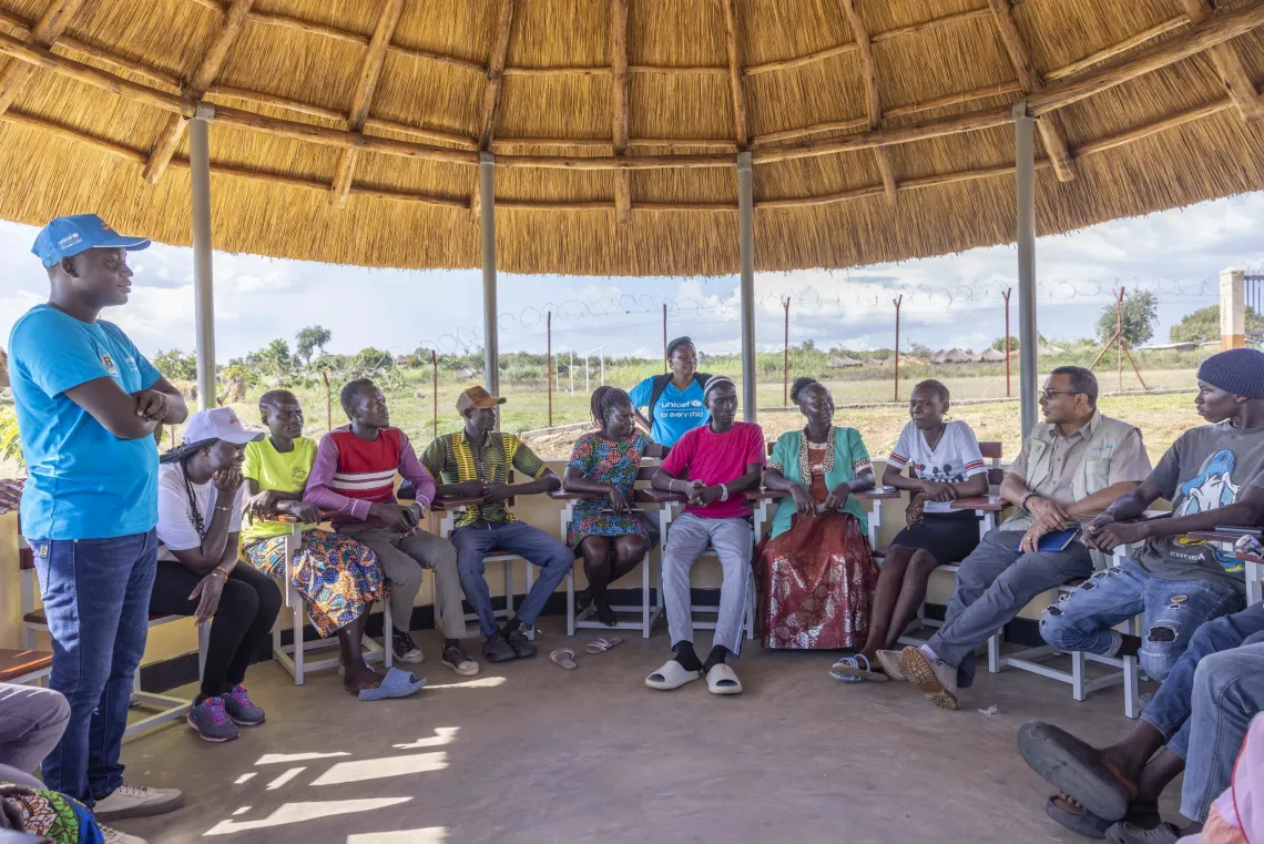 Adolescents participate in a mentorship session on conflict at the Multi-Purpose Community Centre in Imvepi Refugee Settlement, Terego District, joined by UNICEF Country Representative, Dr. Robin Nandy.