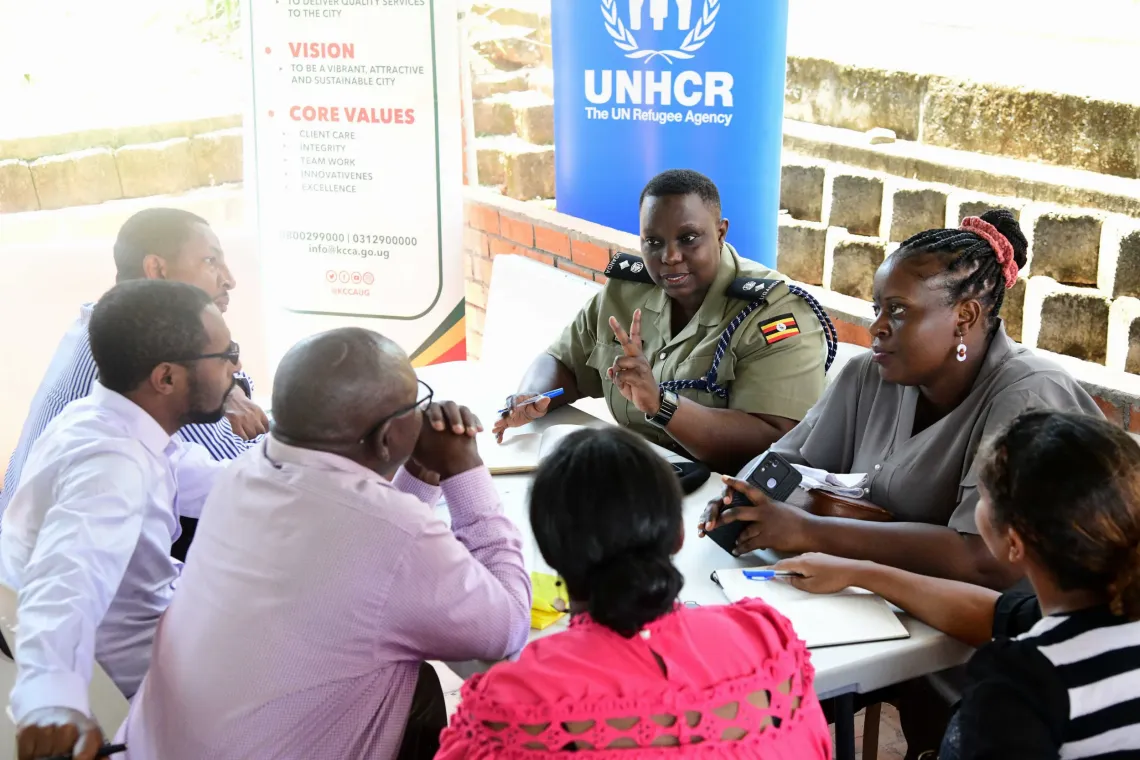 A cross section of multinational delegates from UNICEF, UNHCR and government in group discussion during a field visit at Kampala Capital City Authority central division to pilot an inclusive service delivery model. 