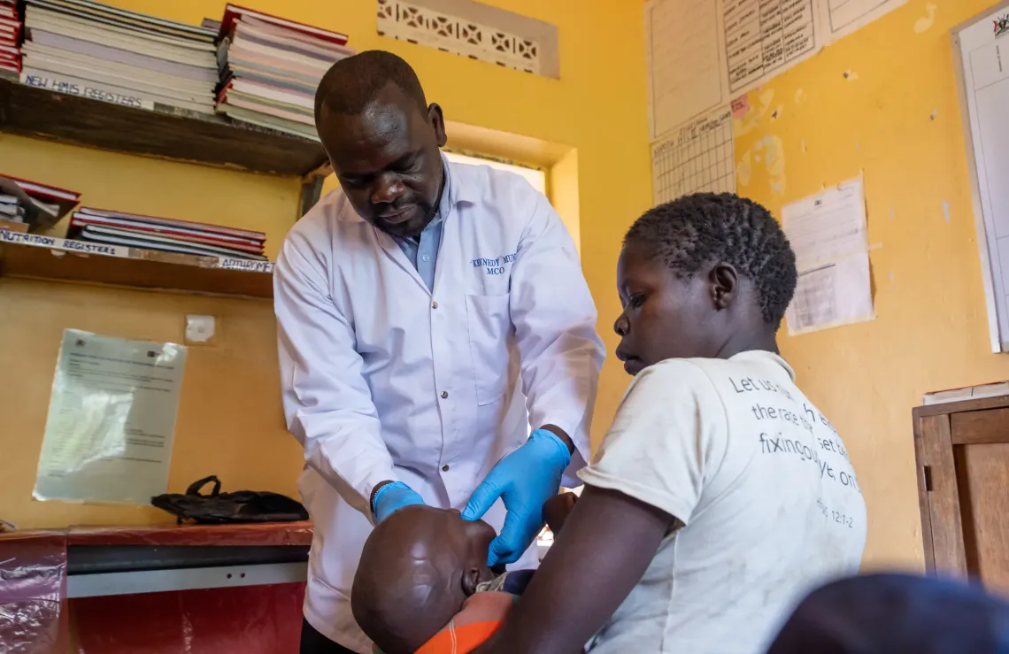 Dr Kenneth Munu attends to patients at Kopoth HCIII, the health facility receiving children referred by Village Health Teams across Sidok subcounty. The OTC here dispenses RUTF every Friday to children enrolled in treatment for Severe Acute Malnutrition.