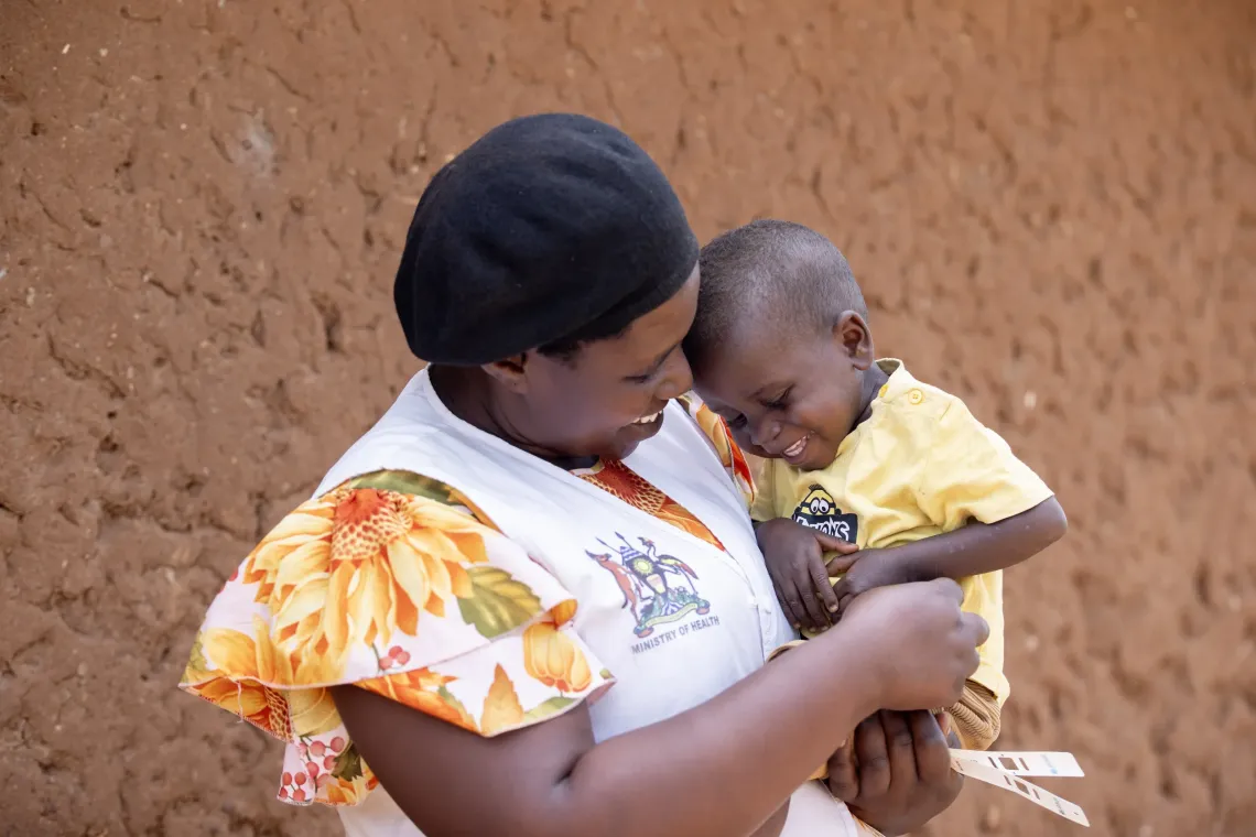 Uwase Christine plays with Raphael after she had just taken him into her home in Nakivale Refugee Settlement, Isingiro District. She found the children abandoned during a follow-up visit and raised them alongside her own. Six months on, both have recovered from severe malnutrition and now call her mother.