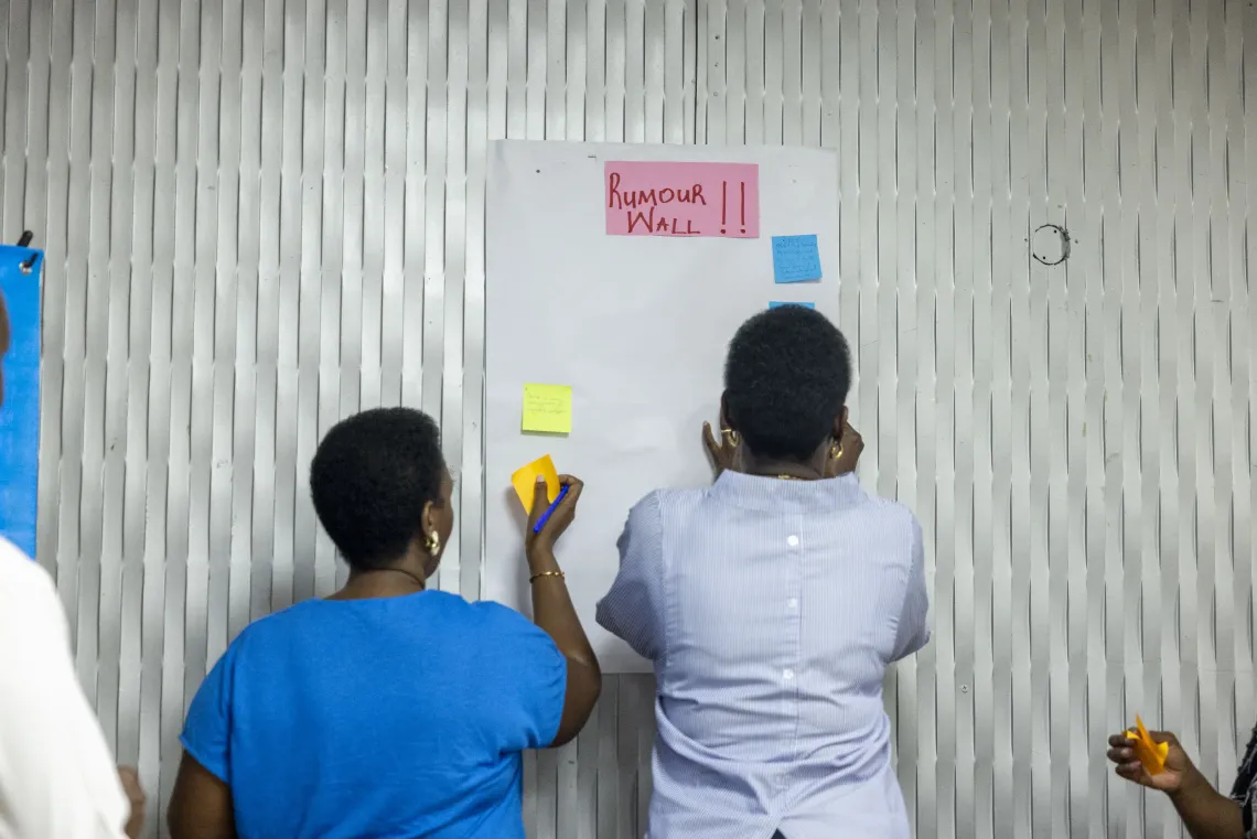 Government Communication Officers contribute examples of rumours and misconceptions about Ebola to the "Rumour Wall" during a practical exercise on identifying and responding to misinformation.