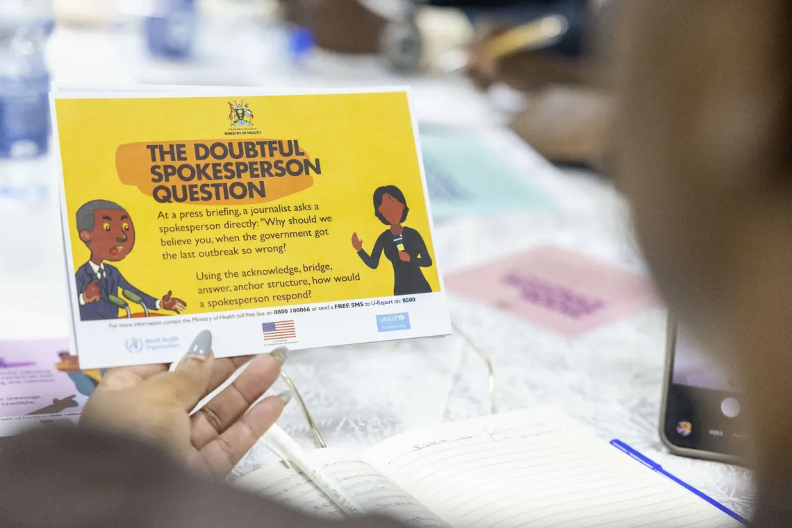 A participant holds a scenario card during a practical exercise designed to strengthen risk communication and crisis communication during public health emergencies.