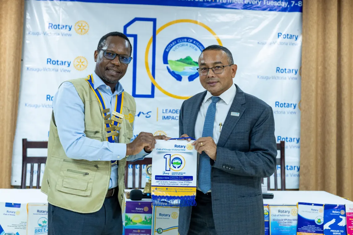 Bernard Tabaire (L), President of the Rotary Club of Kisugu Victoria View, presents a Rotary badge to Dr. Robin Nandy (R), UNICEF Uganda Country Representative, during the inaugural fellowship of the Rotary Club of Kisugu Victoria View for the 2026/2027 Rotary year at Hotel International Muyenga in Kampala, Uganda, on July 7, 2026.