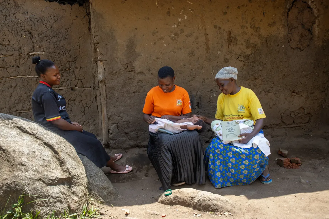 A health worker interacts with a mother and her child, reinforcing key messages on timely care-seeking and child health at the outreach. 