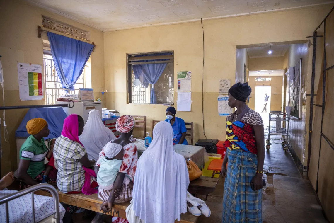 Caregivers wait with their children for nutrition services at Yumbe Health Centre IV in Yumbe District, Uganda.