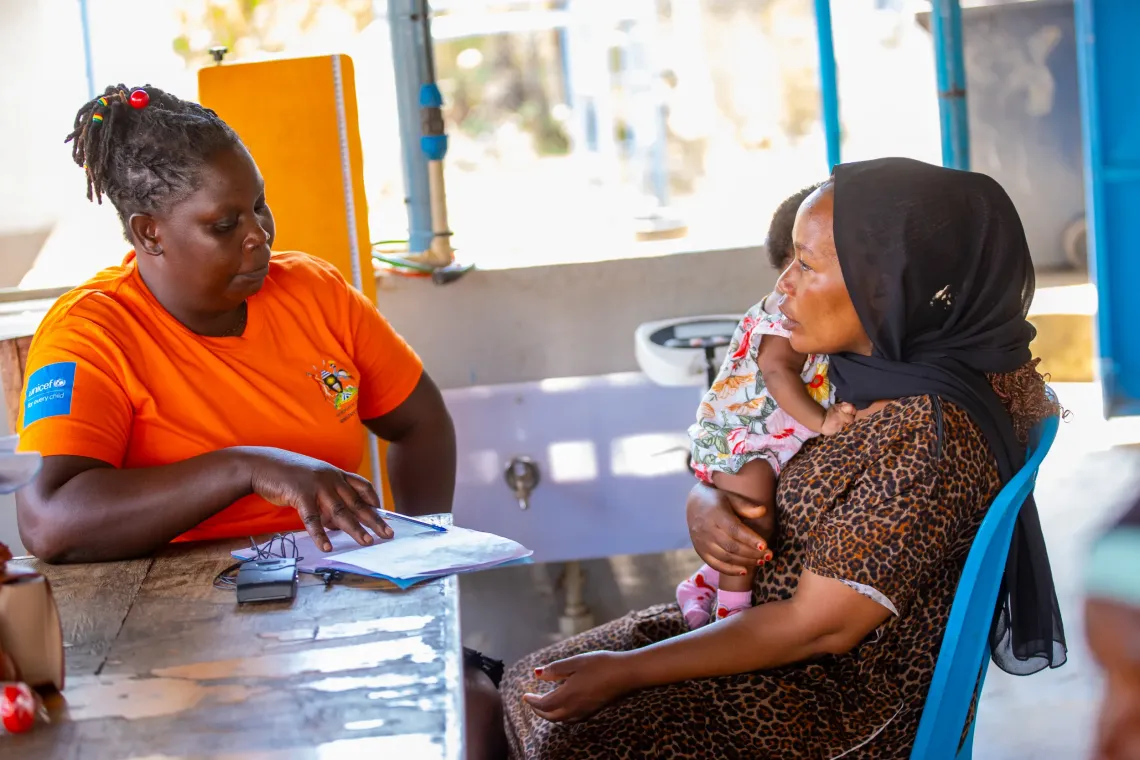 Namutosi Annet, a Community Health Extension Worker (CHEW) attached to &nbsp;Namakwekwe Health Center III, Mbale city talks to Nyamera Sumini during a routine clinic.