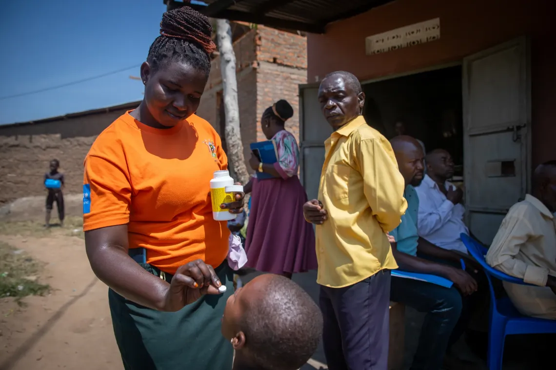 Nagudi Aisha, a Community Health Extension Worker (CHEW) administers Vitamin A to a child at an integrated outreach in Webuta Cell, Bumuyaga Ward, Northern Division, Mbale City supported by Community Health Extension Workers (CHEWs).